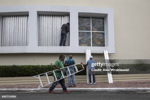 Residents cover windows as they prepare for a direct hit from Hurricane Maria on September 19, 2017 in San Juan, Puerto Rico. Puerto Rico Gov....