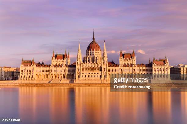 parliament building at sunset, budapest, hungary - budapest stock pictures, royalty-free photos & images