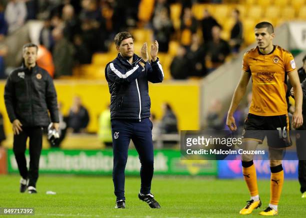 Bristol Rovers manager Darrell Clarke applauds the travelling support following the Carabao Cup tie between Wolverhampton Wanderers and Bristol...