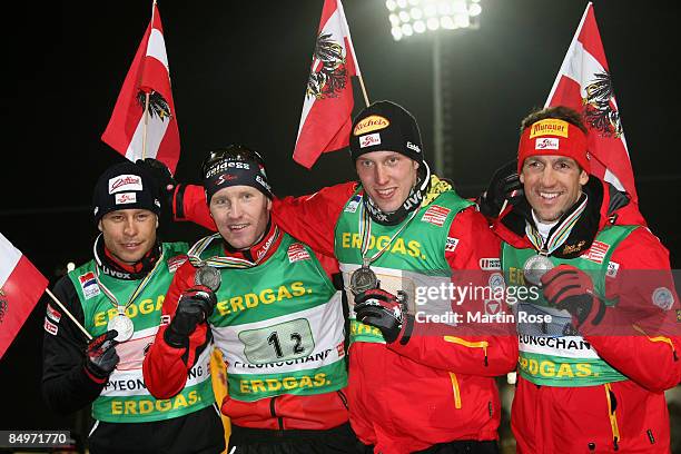 Daniel Mesotitsch, Simon Eder, Dominik Landertinger and Christoph Sumann of Austria pose with the silver medal after the Men's 4x 7,5 km relay of the...
