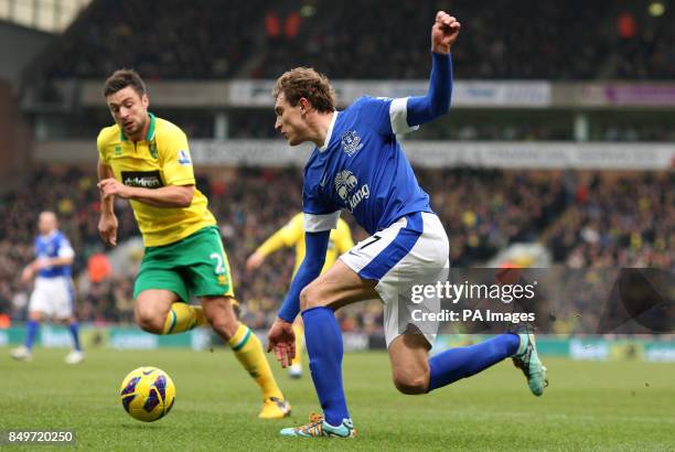Everton's Nikica Jelavic shoots under pressure from Norwich City's Russell Martin during the Barclays Premier League match at Carrow Road, Norwich.