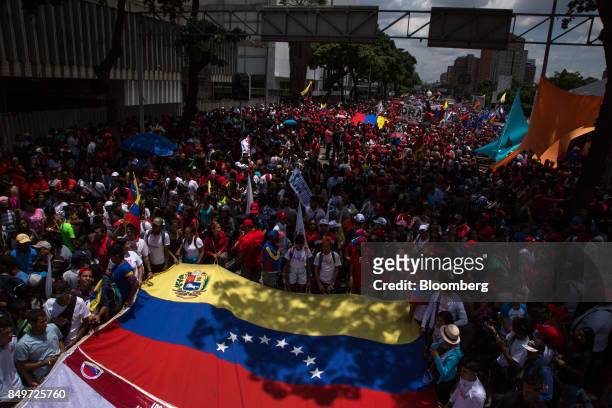 Attendees hold a Venezuelan flag during a rally in support of Nicolas Maduro, Venezuela's president, not pictured, in Caracas, Venezuela, on Tuesday,...