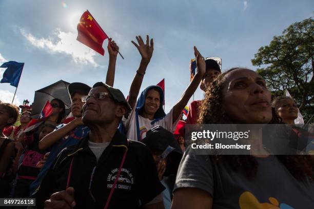 Attendees wave flags during a rally in support of Nicolas Maduro, Venezuela's president, not pictured, in Caracas, Venezuela, on Tuesday, Sept. 19,...