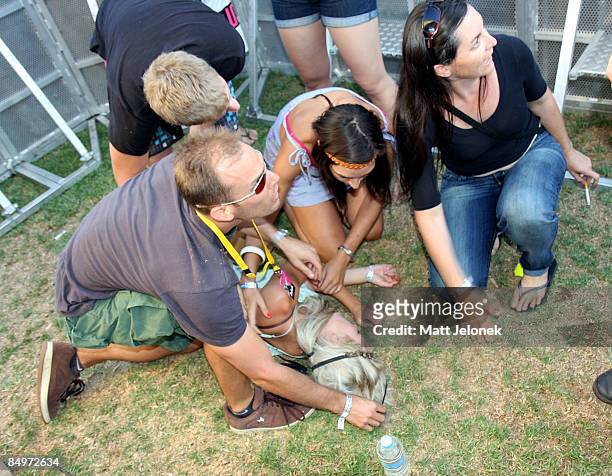 Patron faints and is helped during the Good Vibrations Festival 2009 on Harrison Island on February 22, 2009 in Perth, Australia.