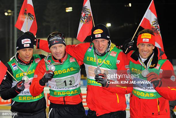 Silver medallists of Austria, Daniel Mesotitsch, Simon Eder, Dominik Landertinger and Christoph Sumann pose on the podium after the men's relay race...