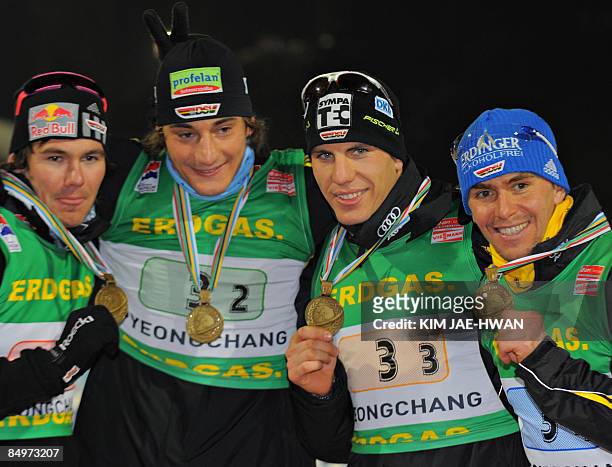 Bronze medalists of Germany, Michael Roesch, Christoph Stephan, Arnd Peiffer and Michael Greis pose on the podium after the men's relay race at the...