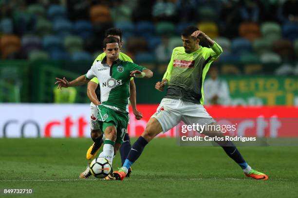 Sporting CP forward Daniel Pondence from Portugal vies with CS Maritimo defender Drausio Gil from Brazil for the ball possession during the match...