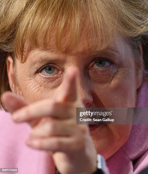 German Chancellor Angela Merkel points during a press conference following a meeting of European Union leaders at the Chancellery on February 22,...