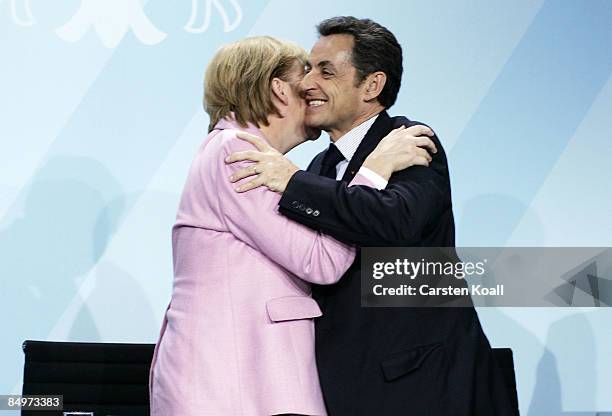 German Chancellor Angela Merkel hugs French President Nicolas Sarkozy upon a press conference after a meeting of European Union leaders at the...