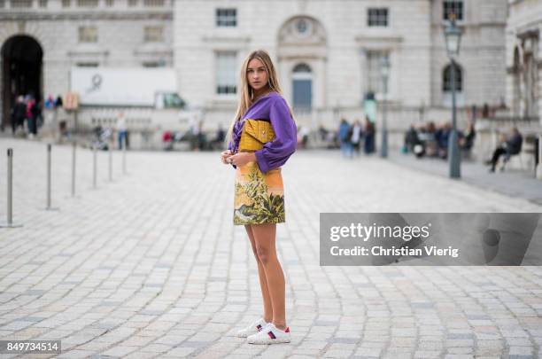 Nina Suess wearing purple Marc Cain blouse, a Marc Cain skirt with a tiger jungle print, yellow Marc Cain bag during London Fashion Week September...