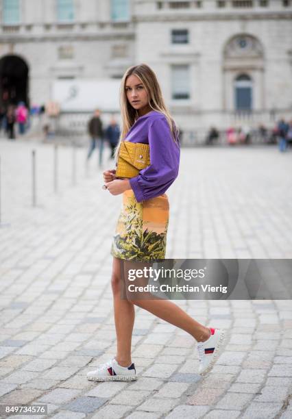 Nina Suess wearing purple Marc Cain blouse, a Marc Cain skirt with a tiger jungle print, yellow Marc Cain bag during London Fashion Week September...