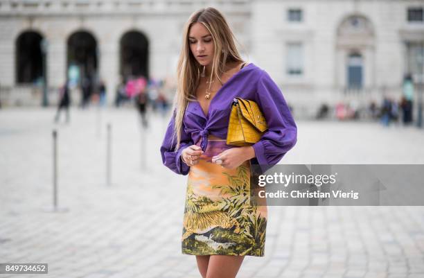 Nina Suess wearing purple Marc Cain blouse, a Marc Cain skirt with a tiger jungle print, yellow Marc Cain bag during London Fashion Week September...