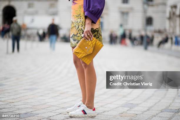 Nina Suess wearing purple Marc Cain blouse, a Marc Cain skirt with a tiger jungle print, yellow Marc Cain bag during London Fashion Week September...