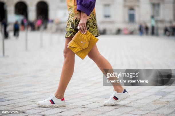Nina Suess wearing purple Marc Cain blouse, a Marc Cain skirt with a tiger jungle print, yellow Marc Cain bag during London Fashion Week September...