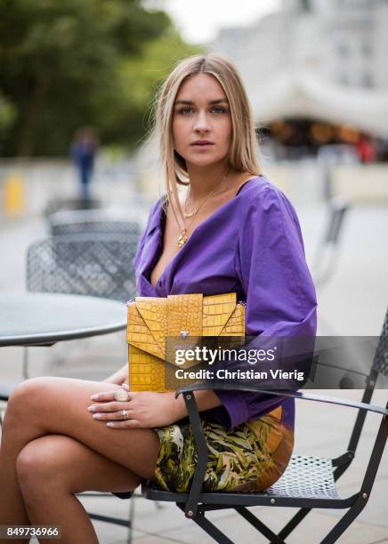 Nina Suess wearing purple Marc Cain blouse, a Marc Cain skirt with a tiger jungle print, yellow Marc Cain bag during London Fashion Week September...