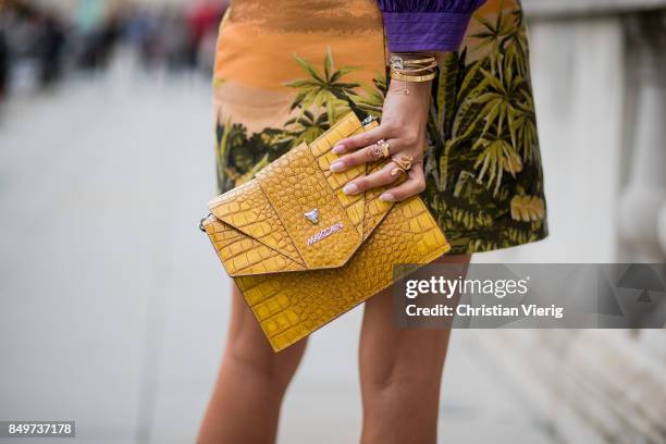 Nina Suess wearing purple Marc Cain blouse, a Marc Cain skirt with a tiger jungle print, yellow Marc Cain bag during London Fashion Week September...