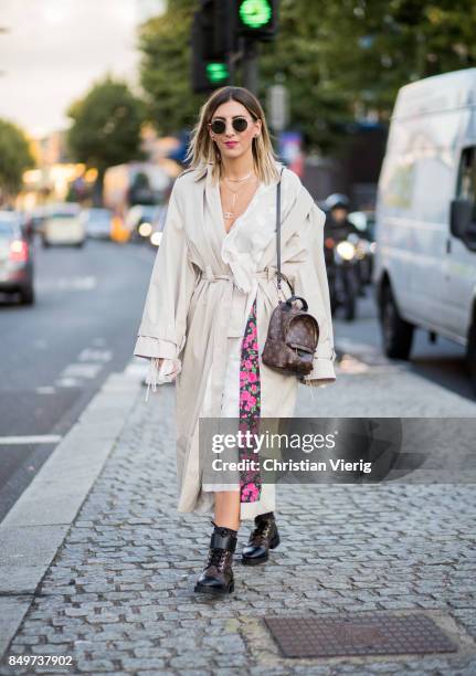 Aylin Koenig wearing white trench, Louis Vuitton backpack outside Tommy Hilfiger during London Fashion Week September 2017 on September 19, 2017 in...