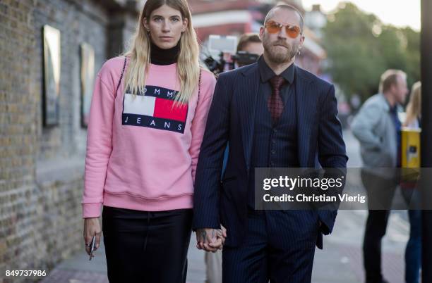 Veronika Heilbrunner wearing pink sweater and Justin O'Shea outside Tommy Hilfiger during London Fashion Week September 2017 on September 19, 2017 in...