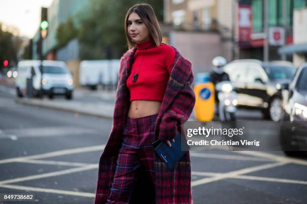 Patricia Manfield wearing checked pants and coat, red cropped top outside Tommy Hilfiger during London Fashion Week September 2017 on September 19,...