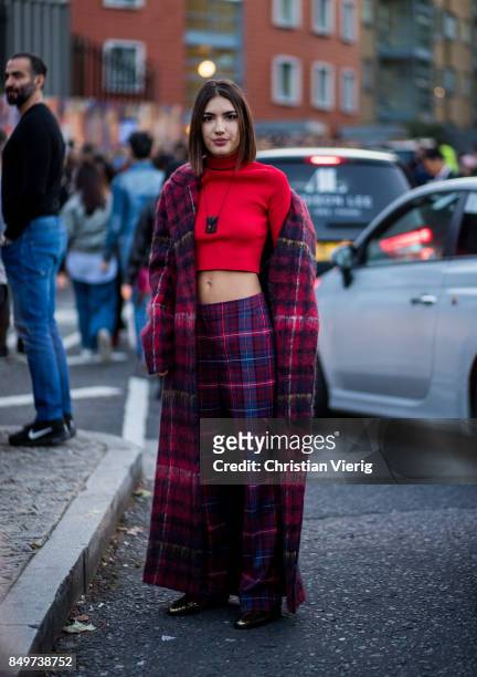 Patricia Manfield wearing checked pants and coat, red cropped top outside Tommy Hilfiger during London Fashion Week September 2017 on September 19,...