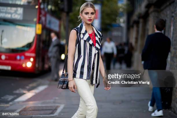Caroline Daur wearing stripped vest, white pants outside Tommy Hilfiger during London Fashion Week September 2017 on September 19, 2017 in London,...