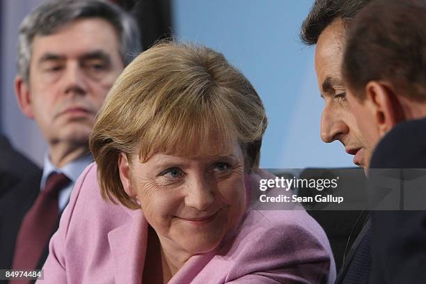 German Chancellor Angela Merkel chats with French President Nicolas Sarkozy and Italian Prime Minister Silvio Berlusconi as British Prime Minister...