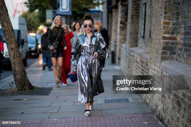 Guest wearing silver dress outside Tommy Hilfiger during London Fashion Week September 2017 on September 19, 2017 in London, England.