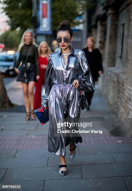 Guest wearing silver dress outside Tommy Hilfiger during London Fashion Week September 2017 on September 19, 2017 in London, England.