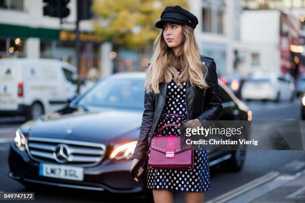 Guest wearing leather jacket, dress, flat cap outside Tommy Hilfiger during London Fashion Week September 2017 on September 19, 2017 in London,...