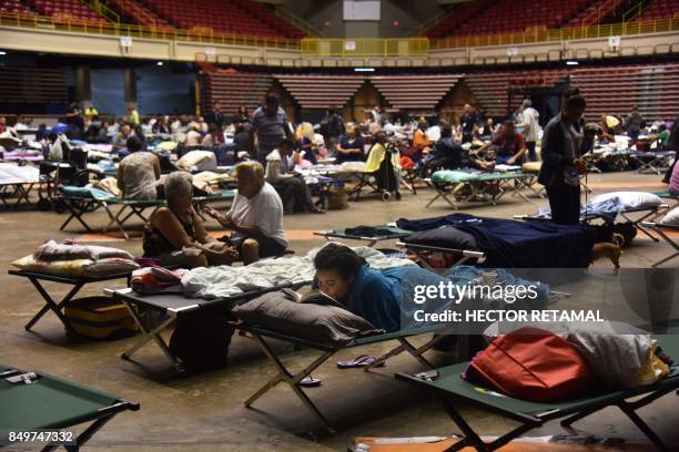 Refugees are seen at the Roberto Clemente Coliseum refuge in San Juan, Puerto Rico, on September 19 prior the arrival of Hurricane Maria. Maria...