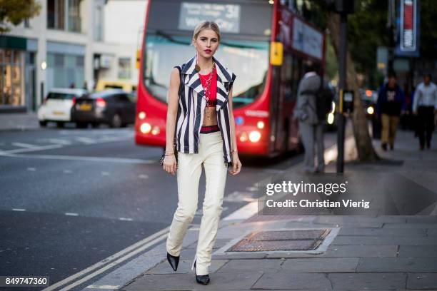 Caroline Daur wearing stripped vest, white pants outside Tommy Hilfiger during London Fashion Week September 2017 on September 19, 2017 in London,...