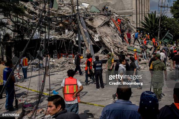 Rescue workers search a collapsed building following an earthquake in the neighborhood of Condesa, Mexico City, Mexico, on Tuesday, Sept. 19, 2017. A...