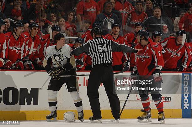 Referee separates Alex Ovechkin of the Washington Capitals and Sidney Crosby of the Pittsburgh Penguins in front of the Washington Capitals bench...