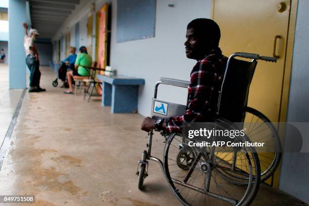 Victor Rivera sits in his wheelchair at a shelter as Hurricane Maria approaches Puerto Rico in Fajardo on September 19, 2017. Maria headed towards...