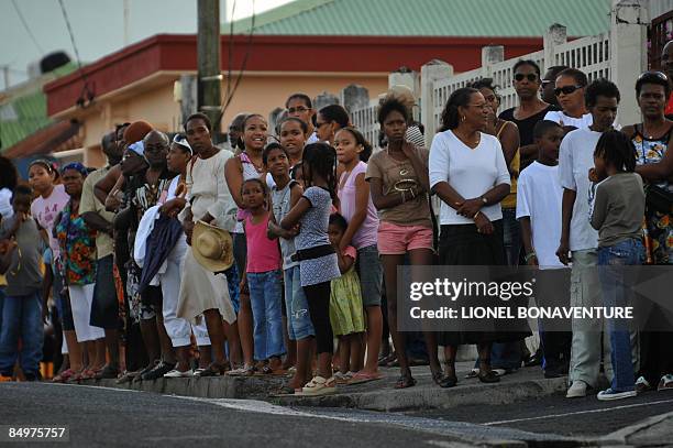 People wait for the unionist Jacques Bino funeral procession to pass on February 22, 2009 in Petit Canal, near Pointe-à-Pitre on the French Caribbean...