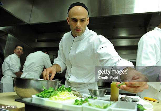 Assistant White House Chef Sam Kass prepares winter citrus salad for tonight during the Governors' dinner preview in the White House kitchen on...