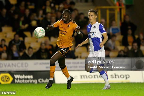 Sylvain Deslandes of Wolverhampton Wanderers competes with Tom NIchols of Bristol Rovers during the Carabao Cup tie between Wolverhampton Wanderers...