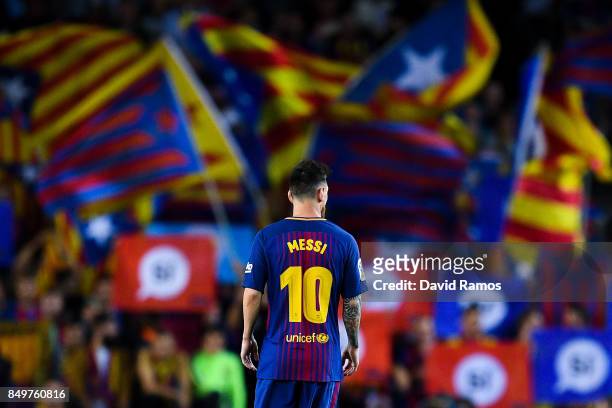 Lionel Messi of FC Barcelona looks on as Catalan Pro-Independence flags are seen on the background during the La Liga match between Barcelona and SD...