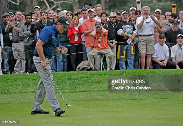 Phil Mickelson reacts after sinking a birdie putt on the 17th green during the final round of the Northern Trust Open held at Riviera Country Club on...