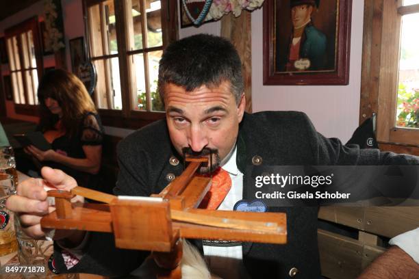 Georg "Schorsch" Hackl snuffs smokeless tobacco with a snuff machine during the "BMW Wies'n Sport-Stammtisch" as part of the Oktoberfest at...