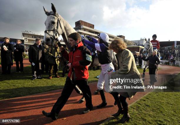 Jockey Peter Buchanan mounts Saphie River in the parade ring ahead of the 5th race, the Coral Cup, on Ladies Day at the 2013 Cheltenham Festival at...