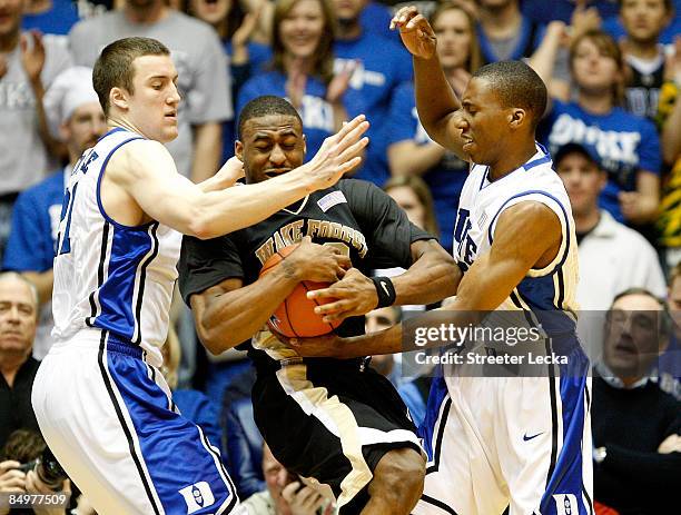 Williams of the Wake Forest Demon Deacons is trapped by teammates Miles Plumlee and Nolan Smith of the Duke Blue Devils during their game at Cameron...