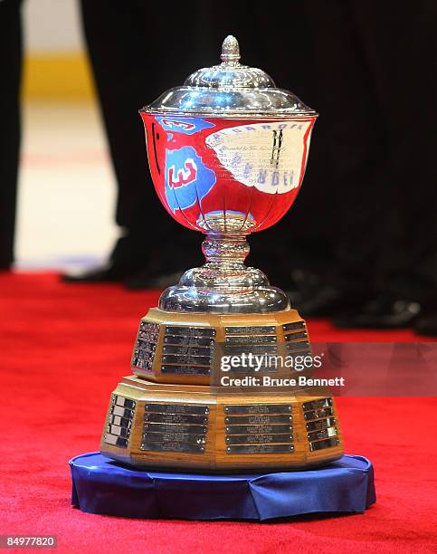 Former New York Ranger player Harry Howell's is reflected in the James Norris Trophy during a ceremony retiring his number prior to the game between...