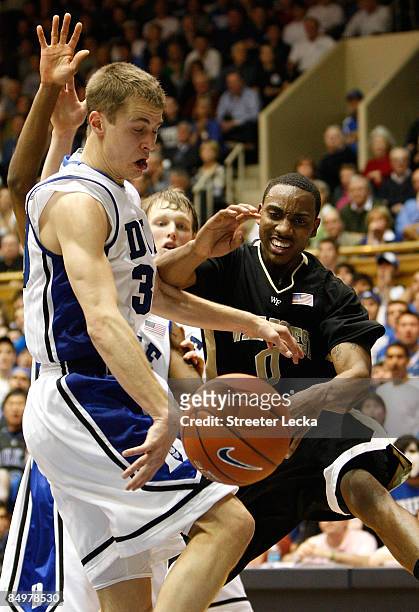 Jeff Teague of the Wake Forest Demon Deacons has the ball taken away by Jon Scheyer of the Duke Blue Devils during their game at Cameron Indoor...