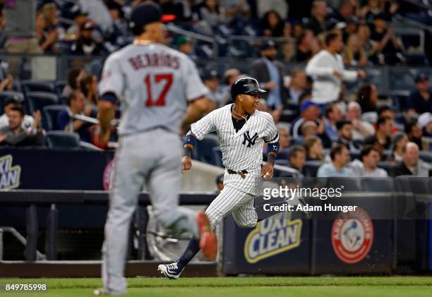 Starlin Castro of the New York Yankees heads home to score a run past Jose Berrios of the Minnesota Twins during the second inning at Yankee Stadium...