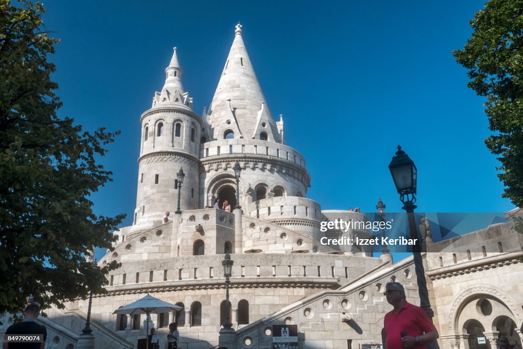 Towers of Fisherman's Bastion and visitor in a red shirt, Budapest, Hungary