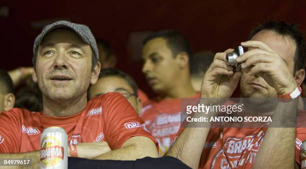 Actor Kevin Spacey admires samba school dancers perform down the Sambodrome on the first night of the Carnival samba school parade in Rio de Janeiro,...