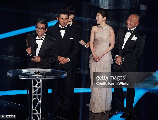 Director Yojiro Takita, actor Masahiro Motoki, actress Ryoko Hirosue and executive producer Yasuhiro Mase accepts the award for Best Foreign Language...