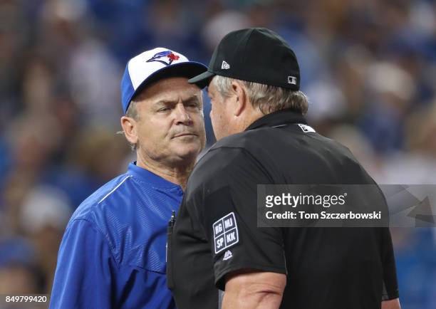 Manager John Gibbons of the Toronto Blue Jays argues with home plate umpire Joe West after he called Marcus Stroman for throwing an illegal pitch in...