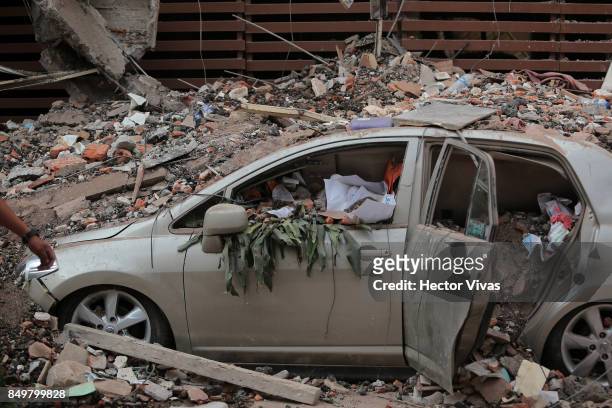 Car is seen destroyed because of the rubble from a building knocked down by a magnitude 7.1 earthquake that jolted central Mexico damaging buildings,...